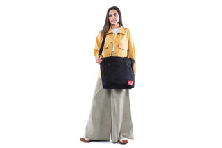 large greenwich tote black held with shoulder strap on female